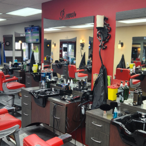 Mirrors, grooming tools and red walls at Empire Barber Shop